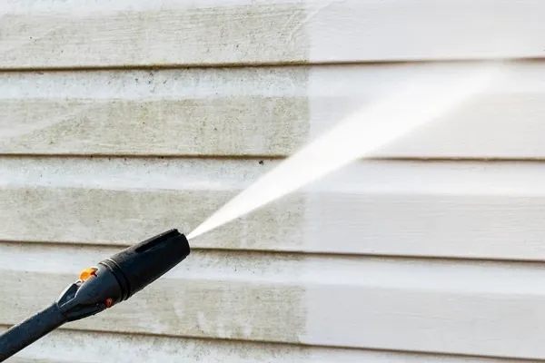 Pressure washing a covered exterior concrete area